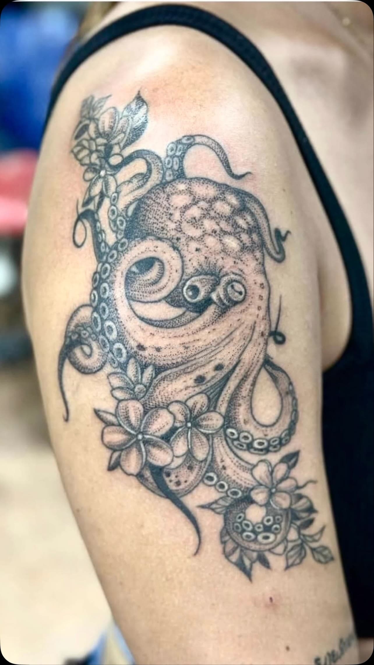 Octopus with flowers tattoo on the shoulder