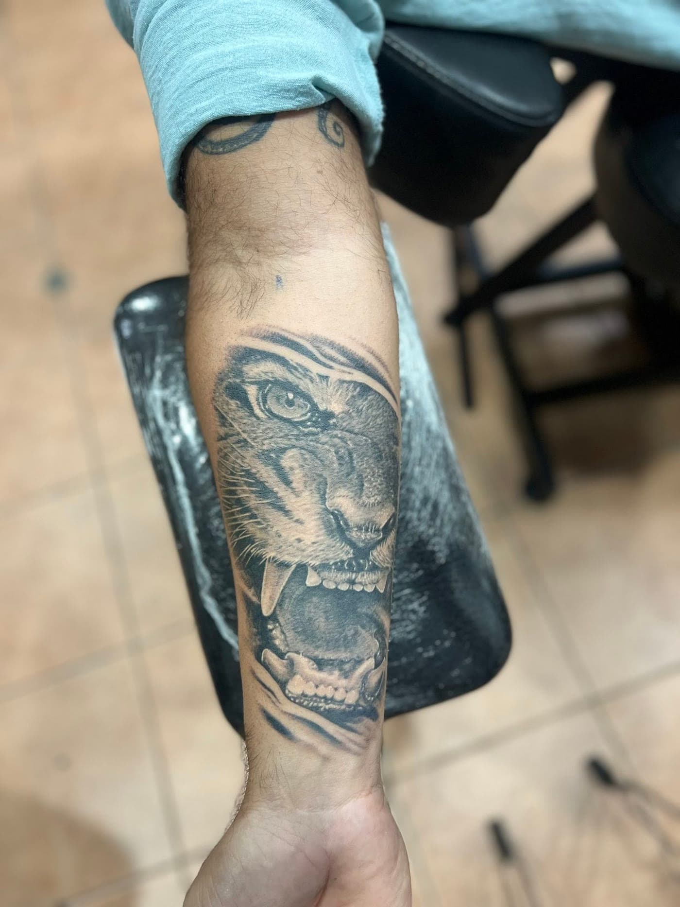 Roaring tiger tattoo on the forearm