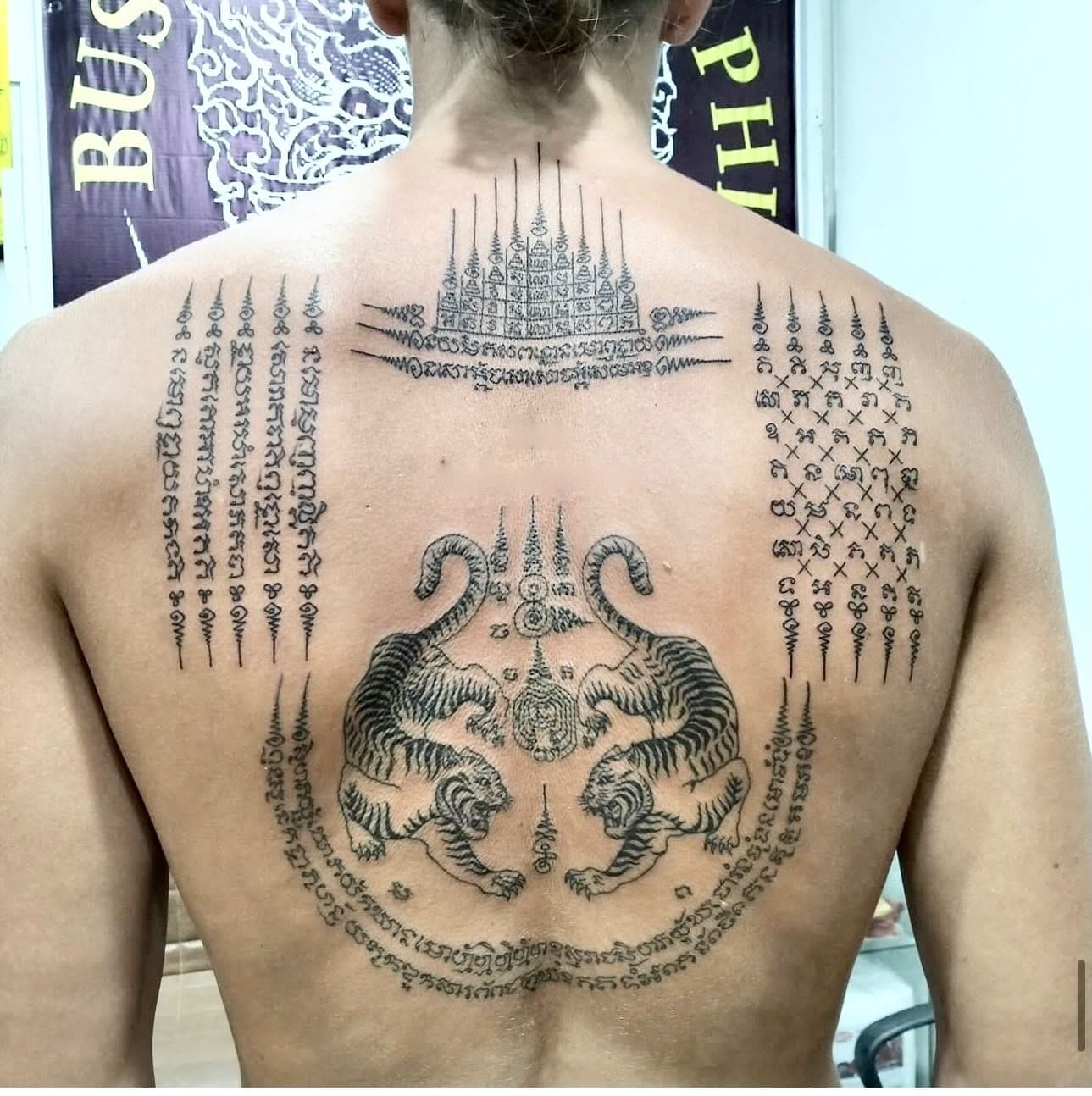 Twin tigers Sak Yant with Gao Yord and Hah Taew on a full back, bamboo tattoo