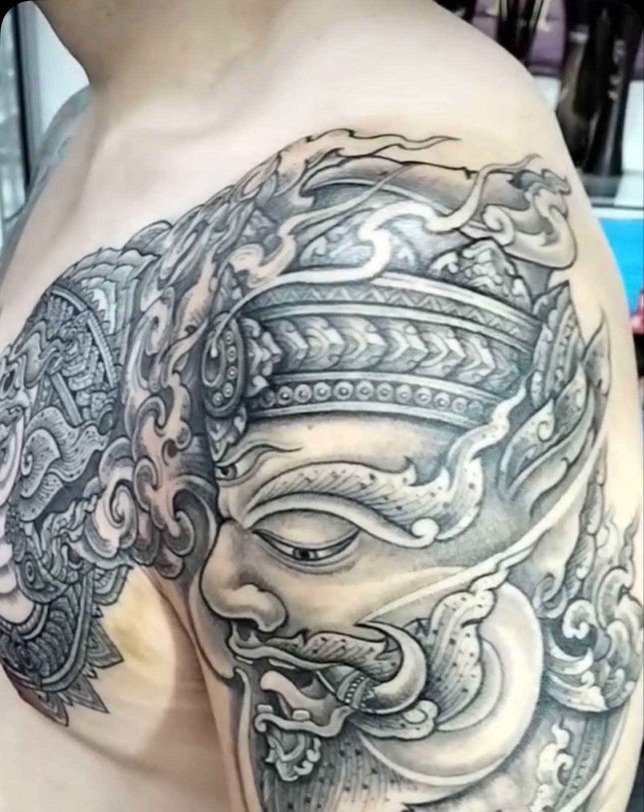 Hanuman Thai guardian tattoo on the shoulder and chest, black and grey